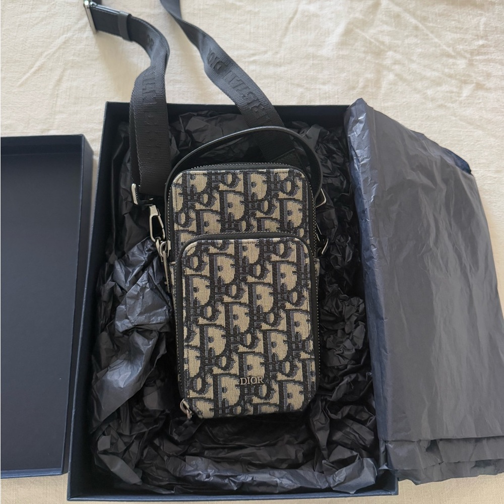 DIOR vertical wallet with strap.